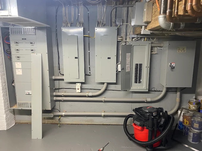 Multiple electrical service panels and conduit runs in a basement mechanical room