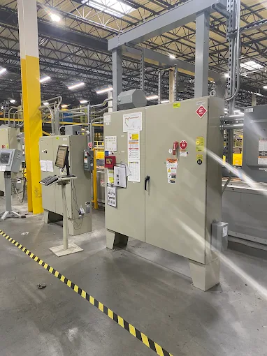 Industrial switchgear and control cabinets on a manufacturing plant floor