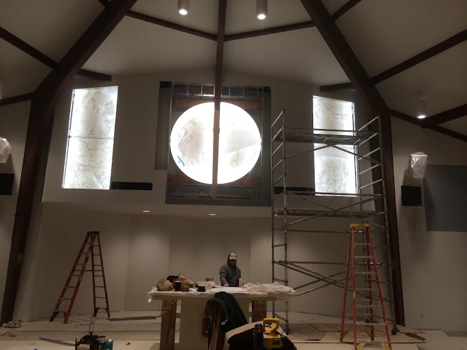 Interior lighting layout being installed around a vaulted ceiling and round window