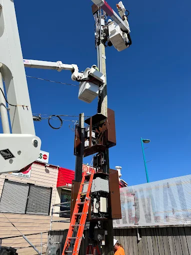 Bucket truck crew working on an overhead utility pole service